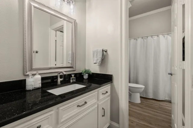 a view of a swimming pool with lawn chairs under an umbrella