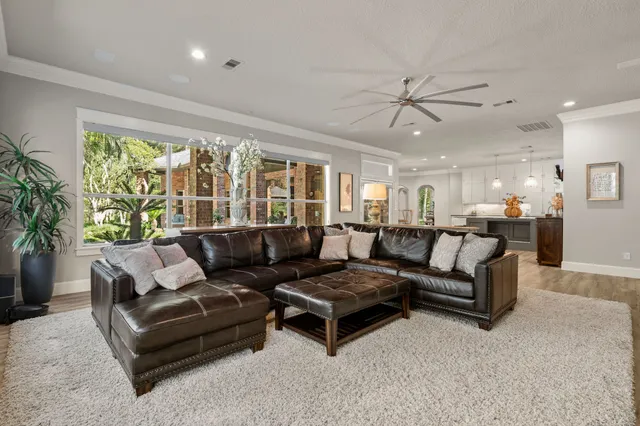 a living room with furniture and a large window