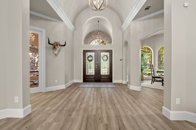 a living room with furniture a window and wooden floor