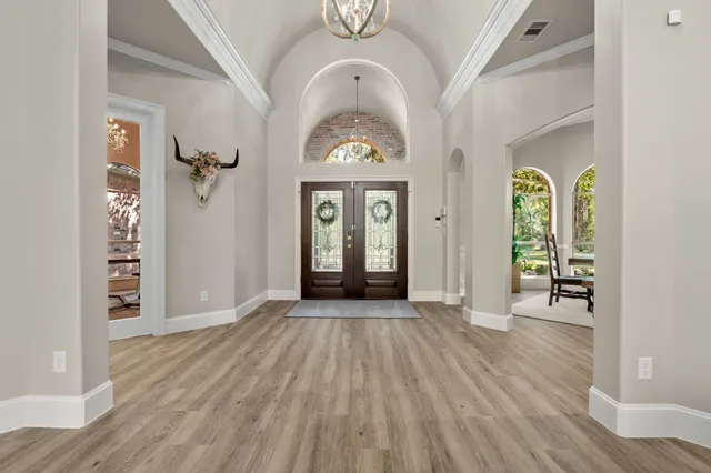 a living room with furniture a window and wooden floor