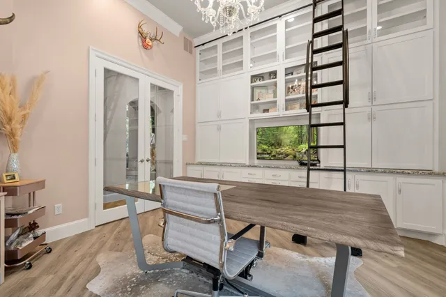 a living room with furniture a fireplace and a large window