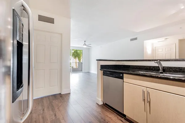 a kitchen with granite countertop a sink and a stove top oven