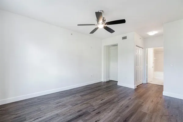 a view of an empty room with wooden floor