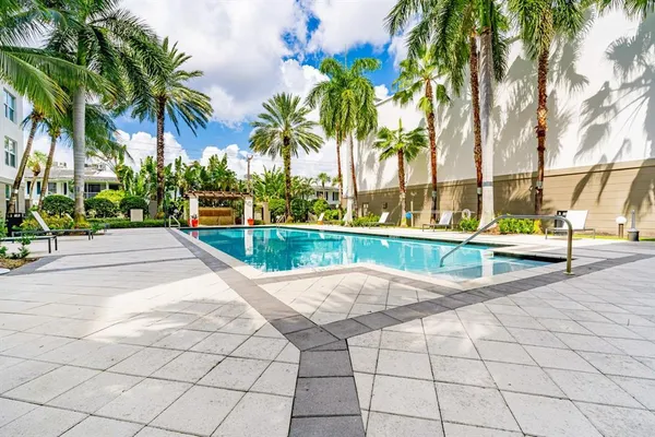 a view of swimming pool with outdoor seating and plants