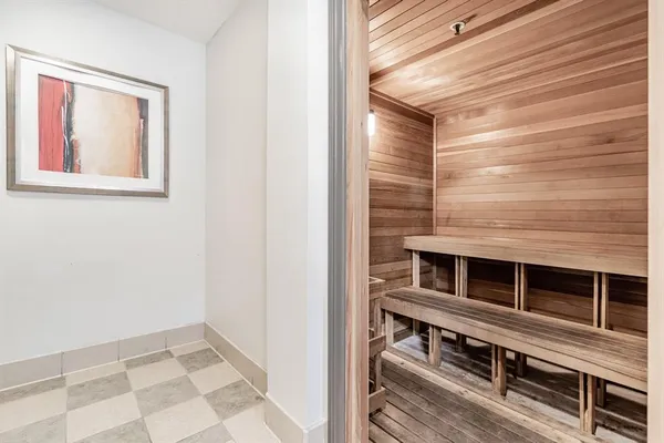 a living room with lots of furniture and view of kitchen