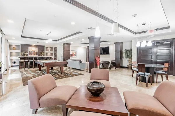 a spacious bedroom with a large bed and potted plant