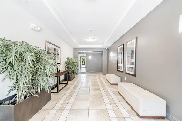 a view of brick building with a yard and plants