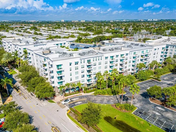 a view of houses with palm trees