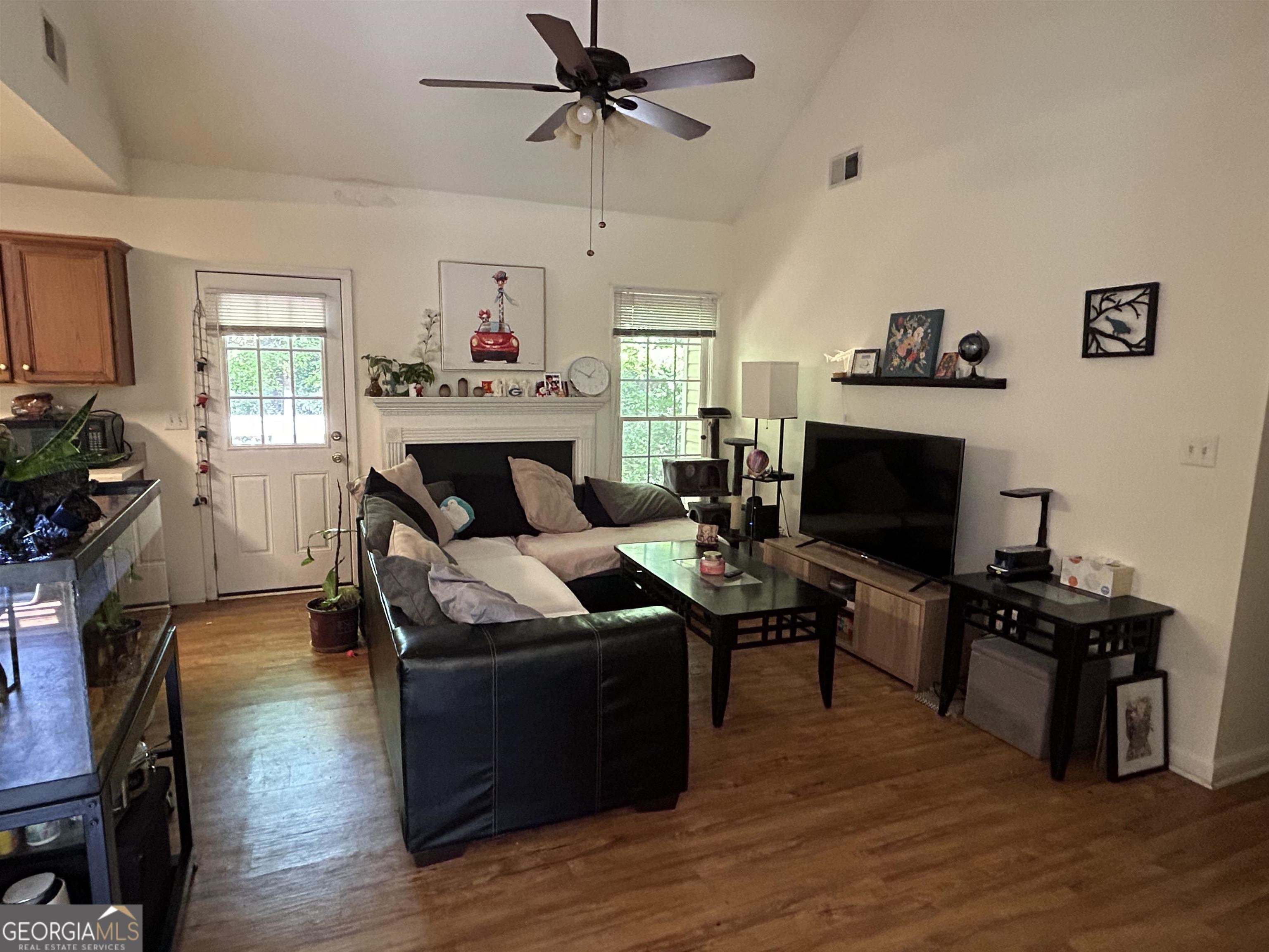 174 Spring Lake Drive Athens, GA 30605 - Photo 2 of 10 a living room with furniture a fireplace and a flat screen tv