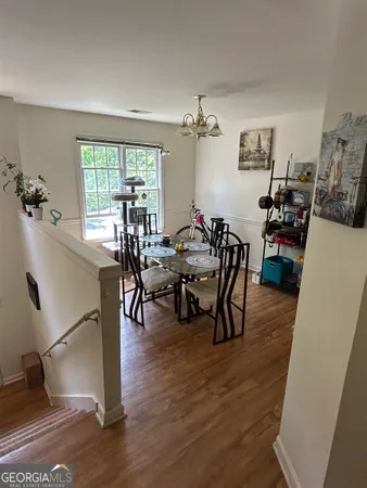a view of a dining room with furniture and wooden floor
