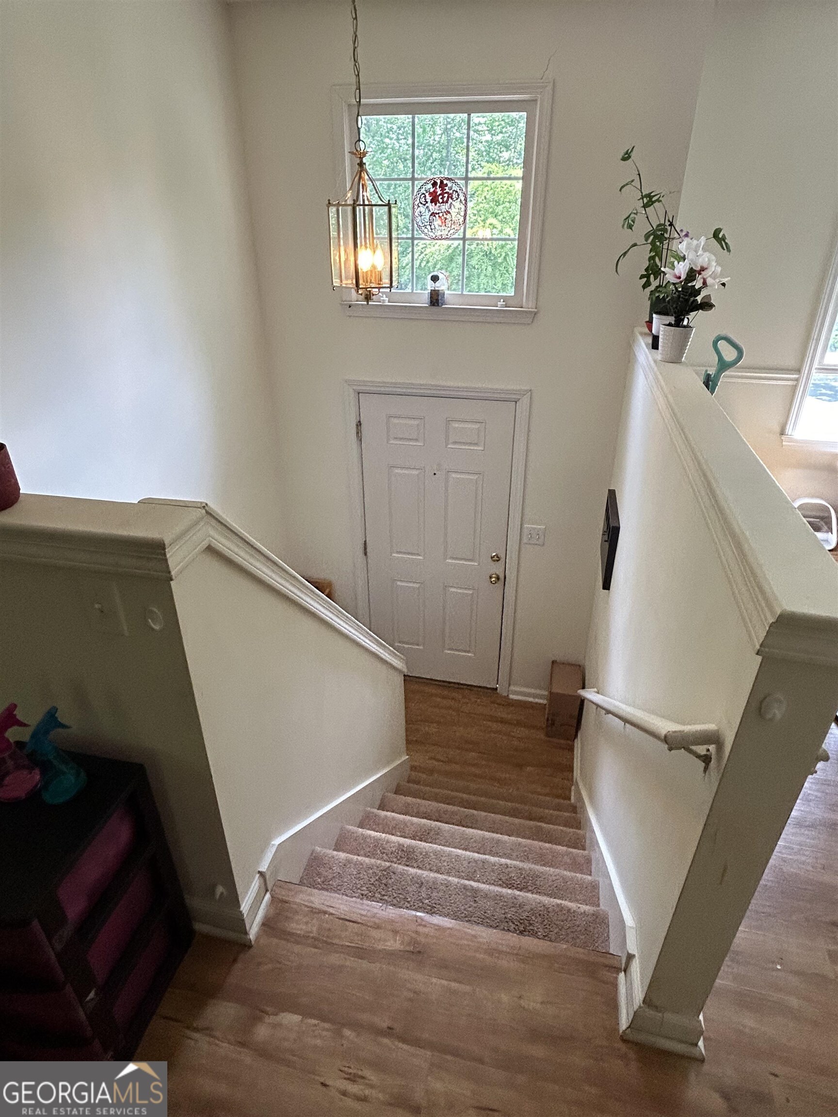 174 Spring Lake Drive Athens, GA 30605 - Photo 4 of 10 a view of a hallway with wooden floor and staircase