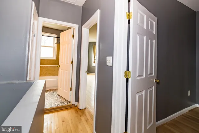a view of an entryway with wooden floor and door