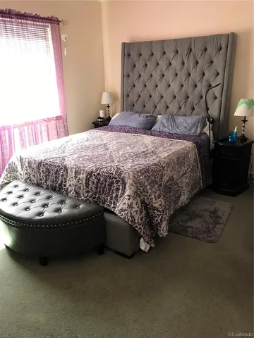 a bed sitting in a bedroom next to a window