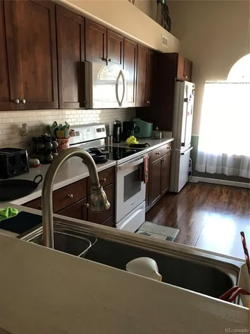 a kitchen with stainless steel appliances a sink a stove and a refrigerator