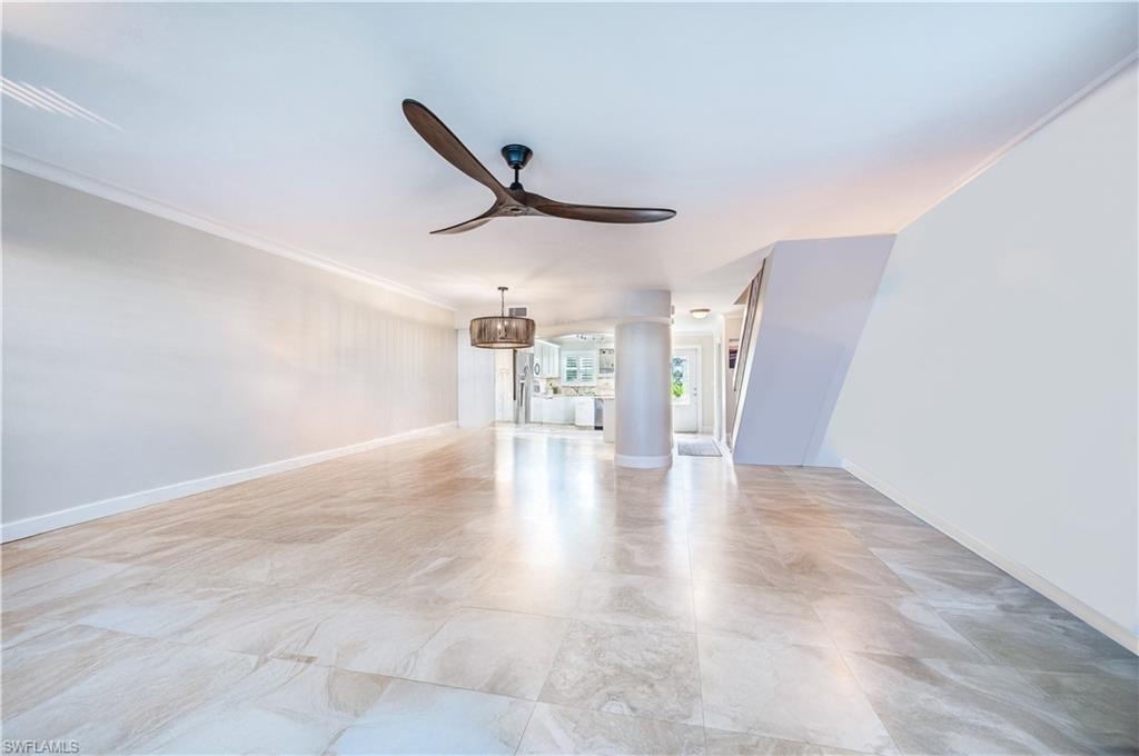 800 River Point Drive, Unit 207 Naples, FL 34102 - Photo 12 of 47 a view of a livingroom with wooden floor and a ceiling fan