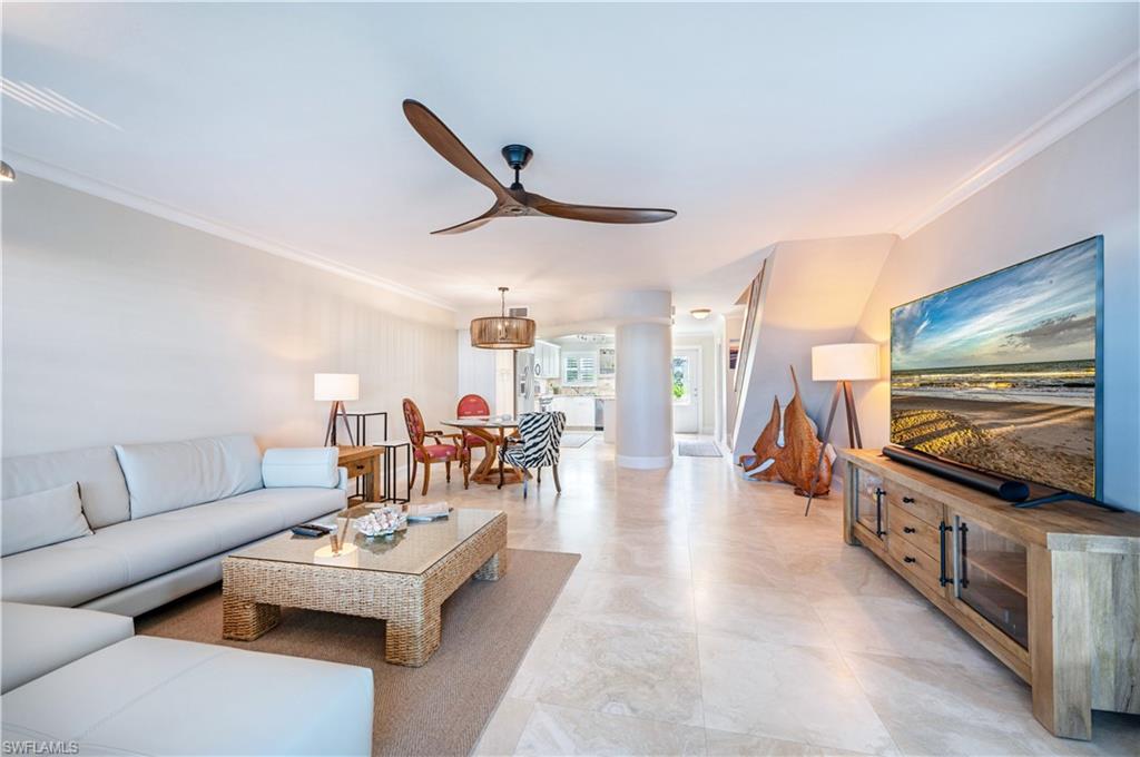 800 River Point Drive, Unit 207 Naples, FL 34102 - Photo 13 of 47 a living room with furniture and a flat screen tv