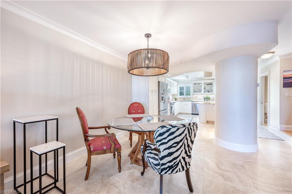 800 River Point Drive, Unit 207 Naples, FL 34102 - Photo 23 of 47 a view of a dining room with furniture and chandelier