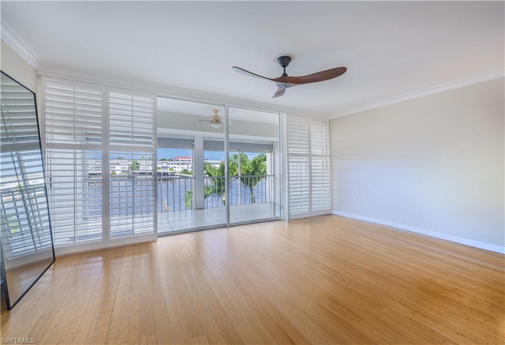 800 River Point Drive, Unit 207 Naples, FL 34102 - Photo 26 of 47 an empty room with wooden floor and windows