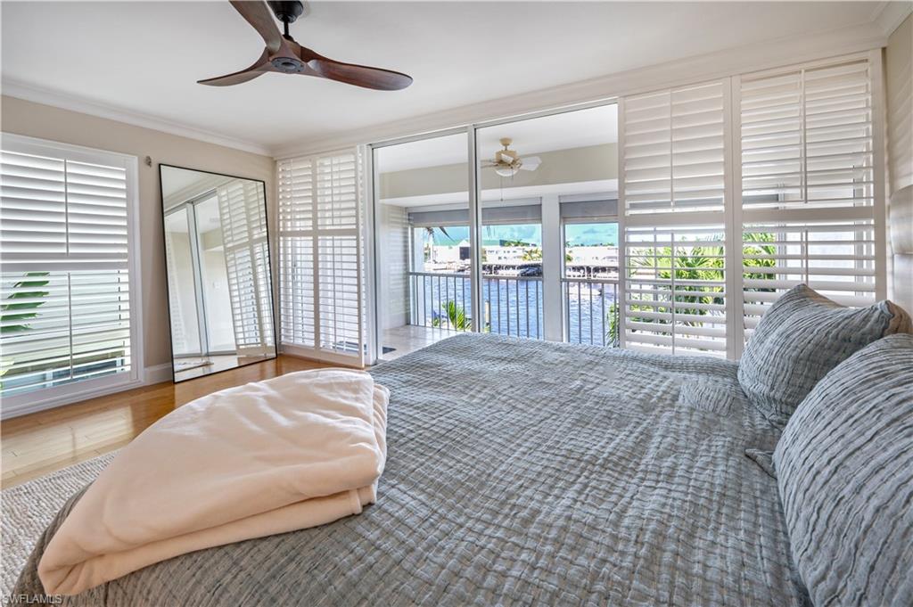 800 River Point Drive, Unit 207 Naples, FL 34102 - Photo 27 of 47 a bedroom with a bed and a large window