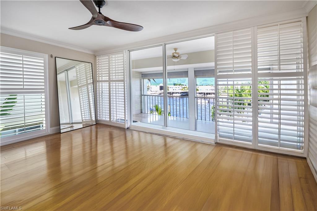 800 River Point Drive, Unit 207 Naples, FL 34102 - Photo 28 of 47 a view of empty room with wooden floor and fan