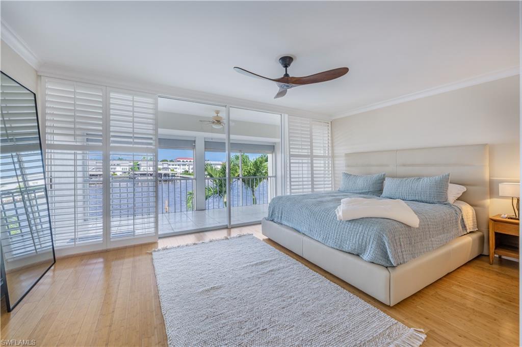 800 River Point Drive, Unit 207 Naples, FL 34102 - Photo 29 of 47 a spacious bedroom with a bed and a table