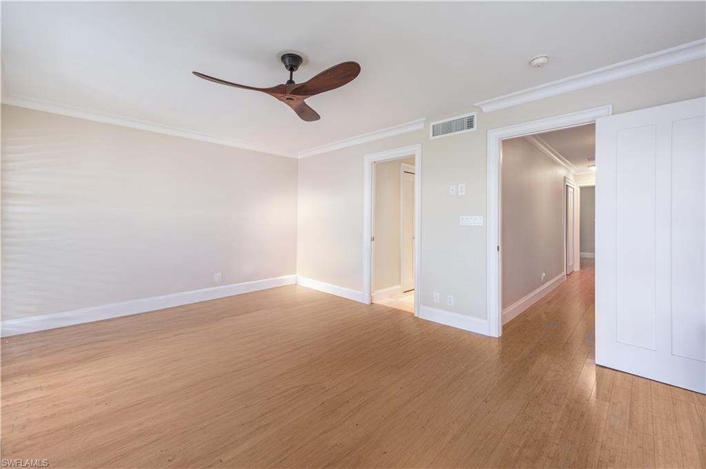 800 River Point Drive, Unit 207 Naples, FL 34102 - Photo 30 of 47 a view of a livingroom with a hardwood floor and a ceiling fan