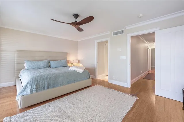 a bedroom with a bed and a ceiling fan