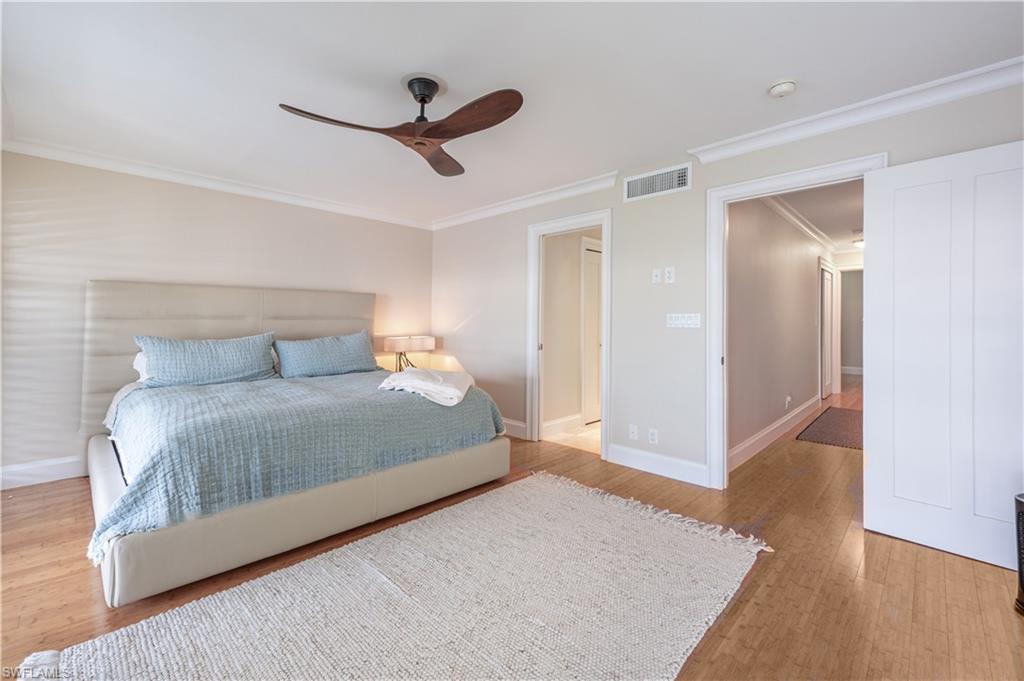 800 River Point Drive, Unit 207 Naples, FL 34102 - Photo 31 of 47 a bedroom with a bed and a ceiling fan