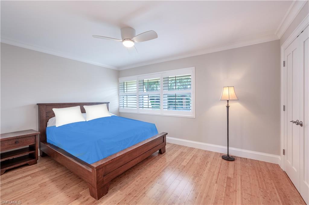 800 River Point Drive, Unit 207 Naples, FL 34102 - Photo 37 of 47 a bedroom with a bed and a night stand