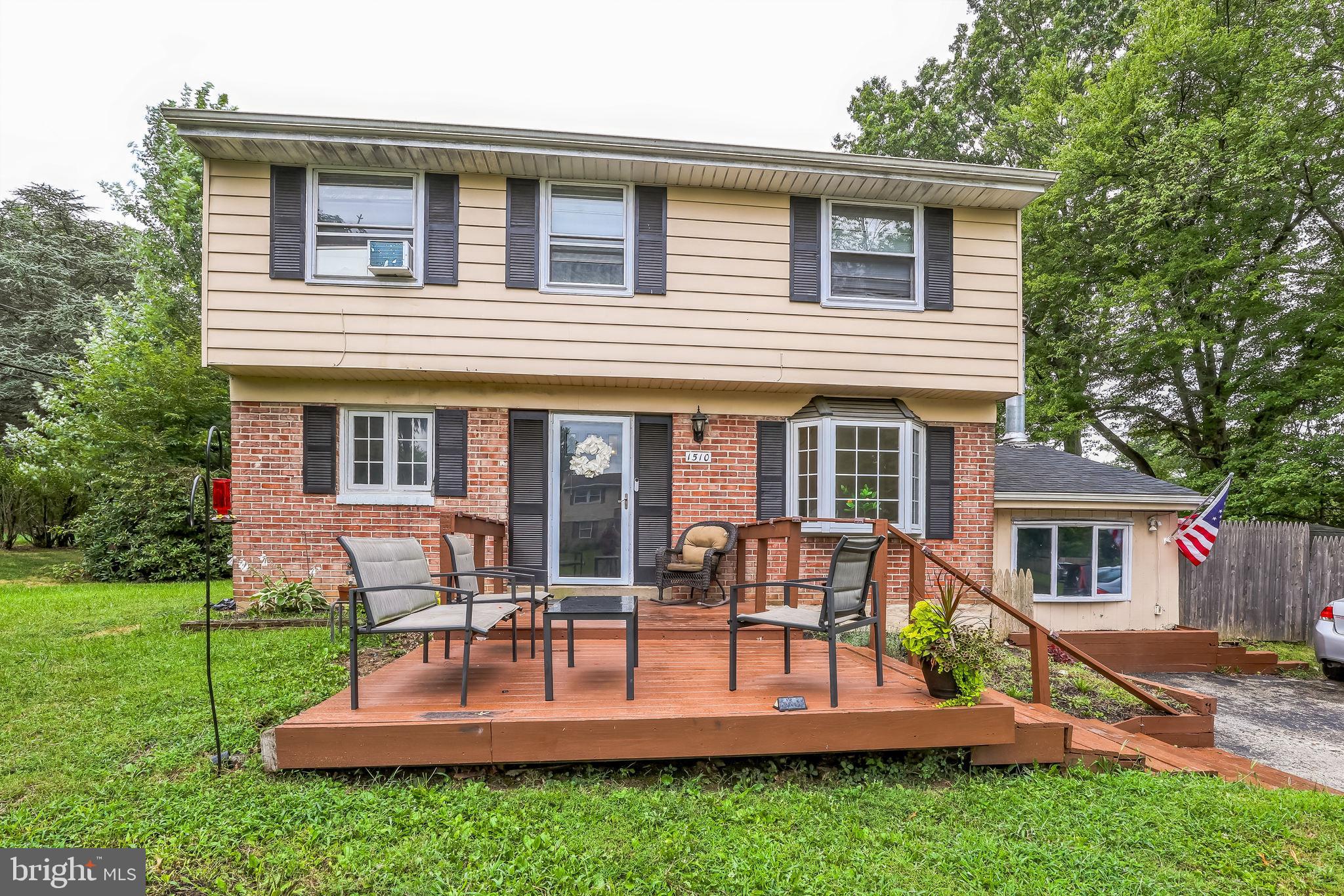 front view of house with a yard and patio