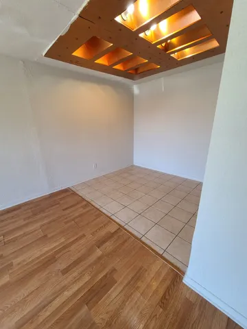 a view of a room with wooden floor