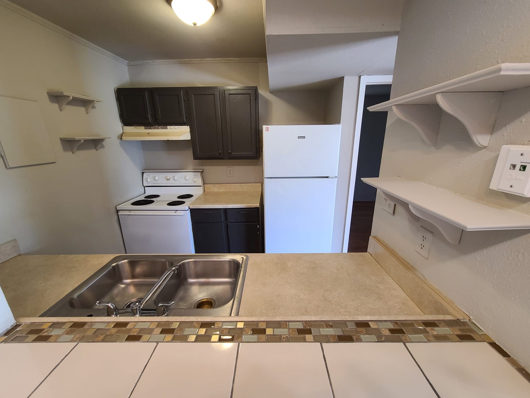500 Austin Road, Unit 3 Eagle Lake, TX 77434 - Photo 3 of 11 a kitchen with a refrigerator and a stove top oven