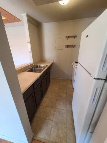 a kitchen with a stove and a refrigerator