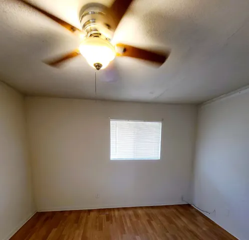 a view of a ceiling fan and a window