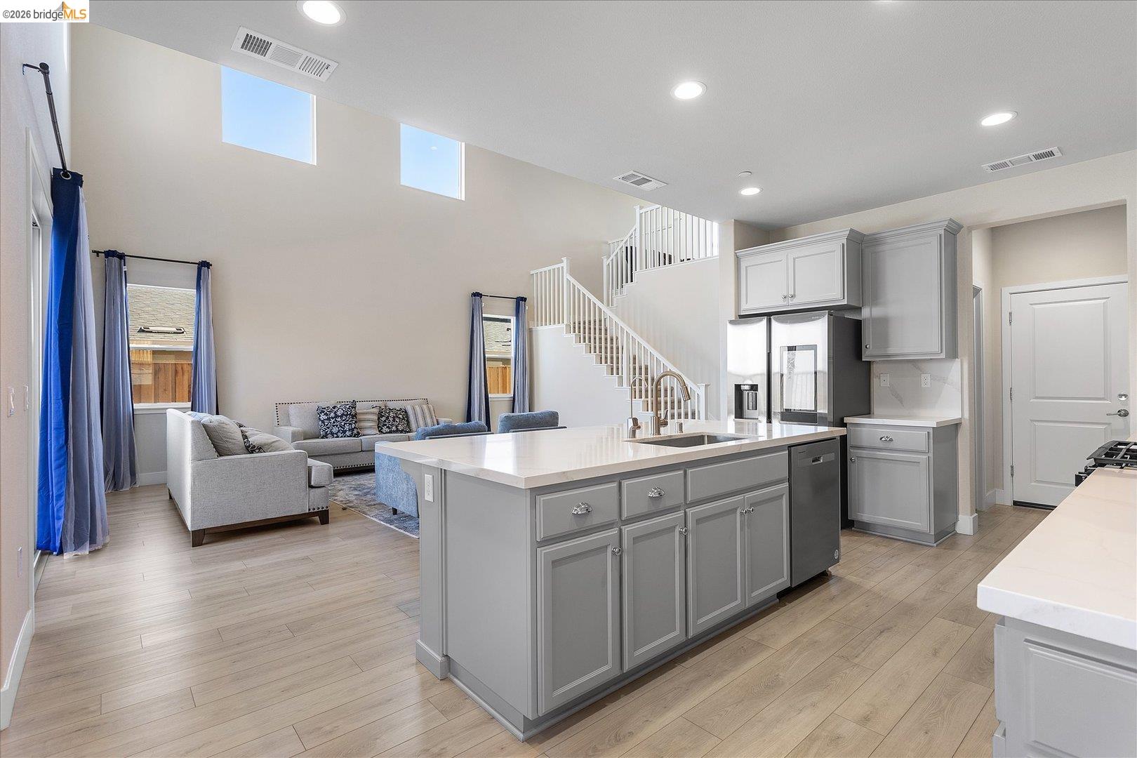 5601 Ridgepoint Way Antioch, CA 94531 - Photo 14 of 59 Open-concept living space with a kitchen island featuring a sink and dishwasher