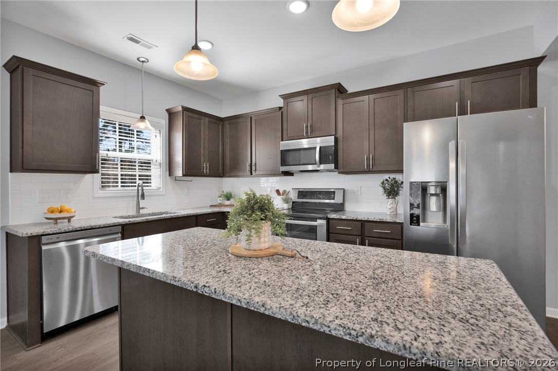 258 Fieldbrook Street Raeford, NC 28376 - Photo 12 of 40 a kitchen with stainless steel appliances granite countertop a sink refrigerator and microwave