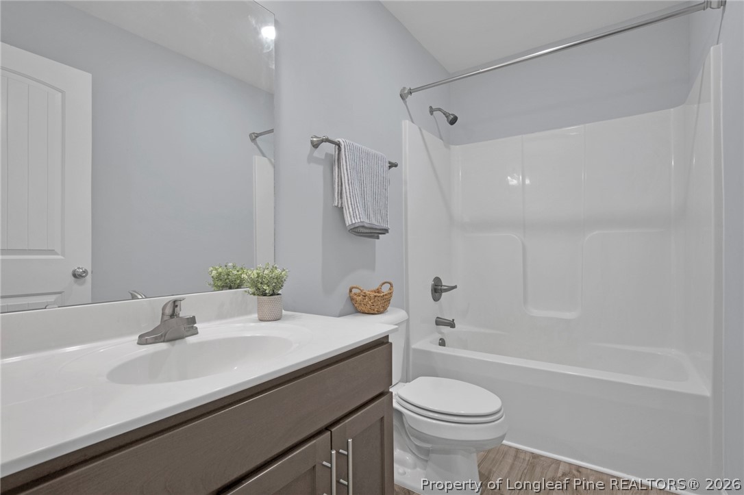 258 Fieldbrook Street Raeford, NC 28376 - Photo 23 of 40 a bathroom with a sink a toilet and a mirror