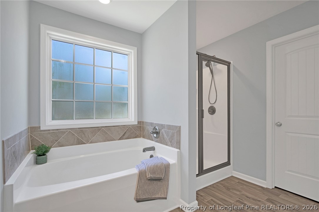 258 Fieldbrook Street Raeford, NC 28376 - Photo 32 of 40 a bathroom with a bathtub and a shower