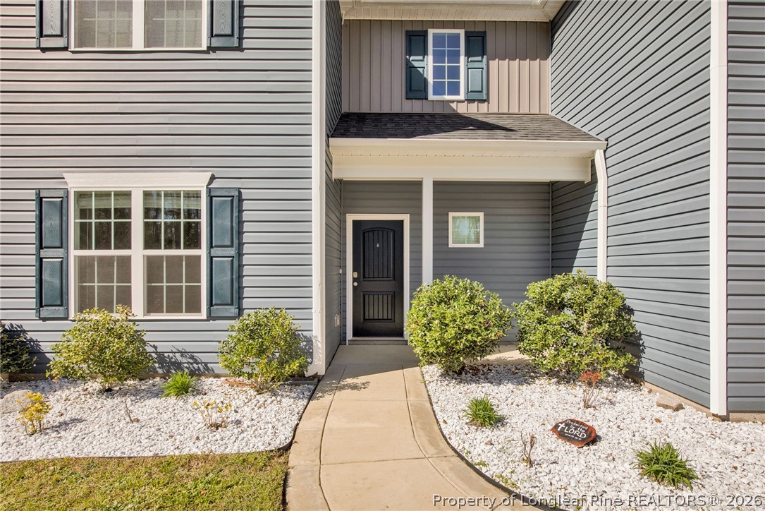 258 Fieldbrook Street Raeford, NC 28376 - Photo 4 of 40 a view of a house with a small window and potted plants