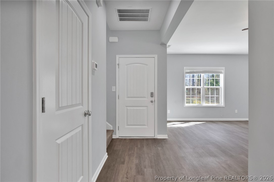 258 Fieldbrook Street Raeford, NC 28376 - Photo 5 of 40 a view of an empty room with wooden floor and a window