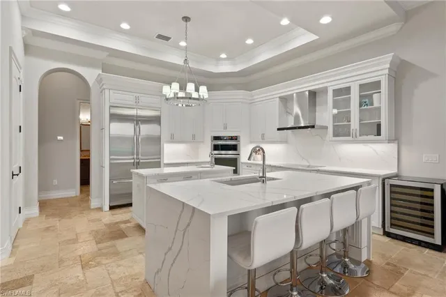 a large white kitchen with a stove top oven a sink and dishwasher