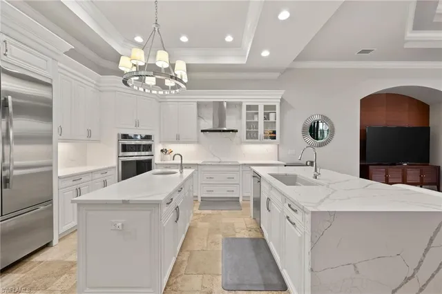 a large kitchen with kitchen island a stove a table and chairs in it