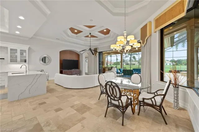 a living room with large windows and a flat screen tv