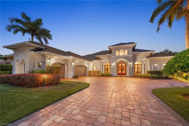 a backyard of a house with lots of green space and fountain