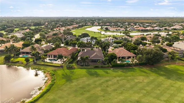 an aerial view of residential houses with outdoor space and trees