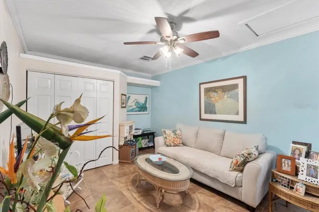 a living room with furniture and a painting on the wall