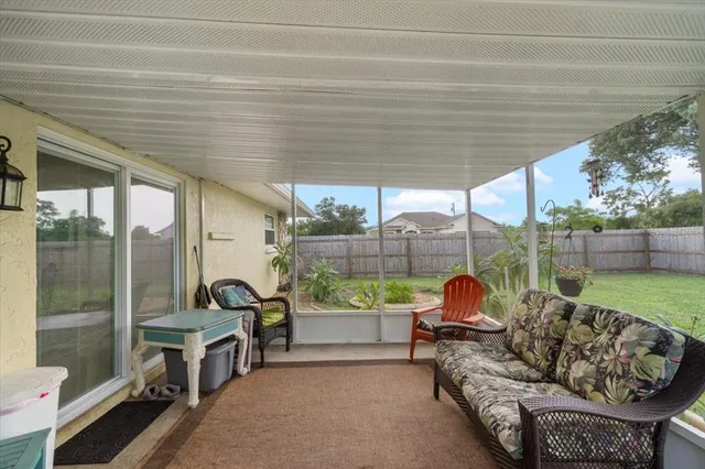 a balcony with furniture and a garden