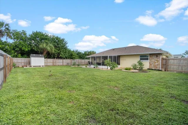 a backyard of a house with table and chairs