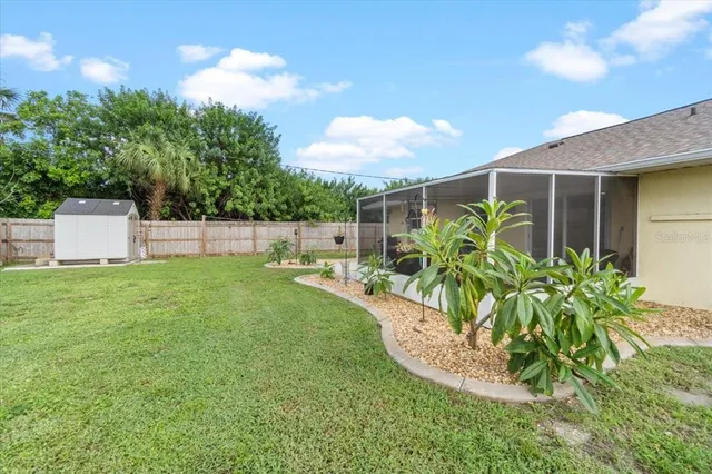 a view of a backyard with plants and a patio