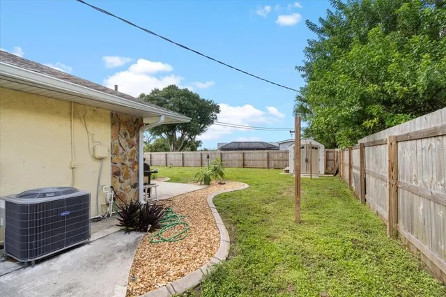 a view of a backyard with wooden fence